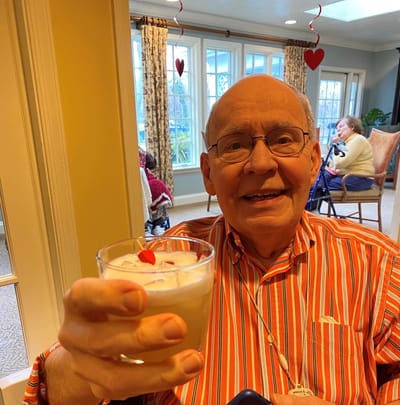 A resident enjoying a drink in a common area