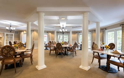 Bright dining room with tables and flowers