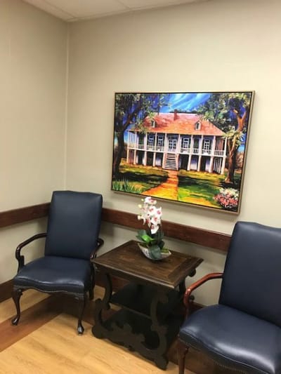Artwork of a house hanging in a waiting area