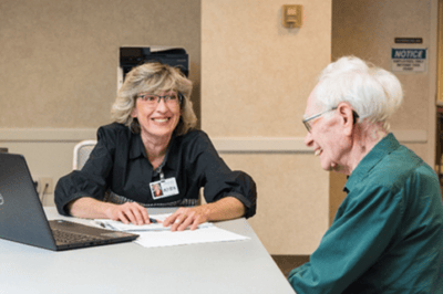 Staff member engaging with a resident at a table