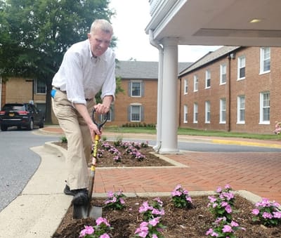 Resident planting flowers in outdoor space