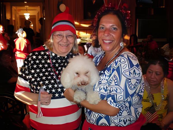 Residents celebrating with an adorable dog during an event