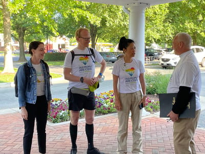 Staff and guests engaging at the facility entrance