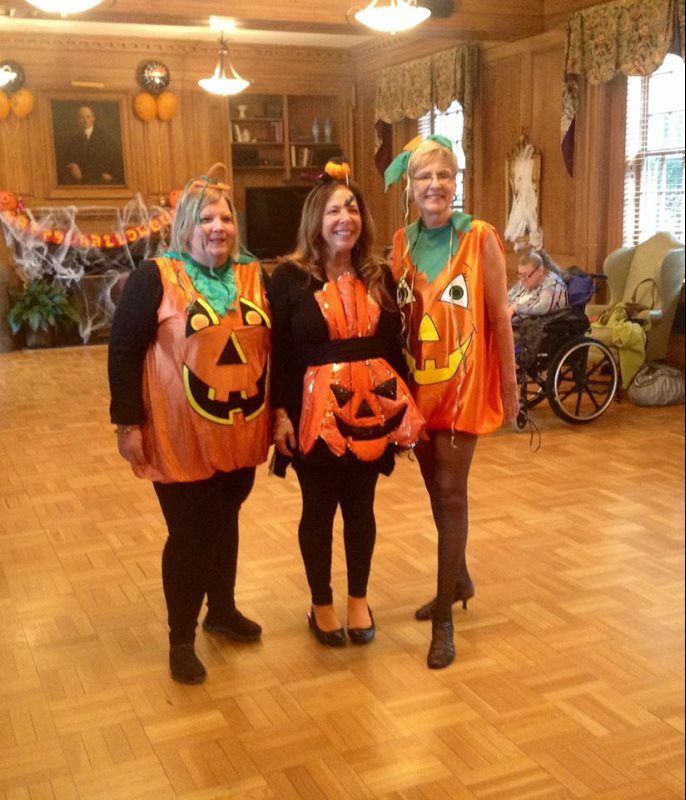 Staff dressed in Halloween costumes at a festive event
