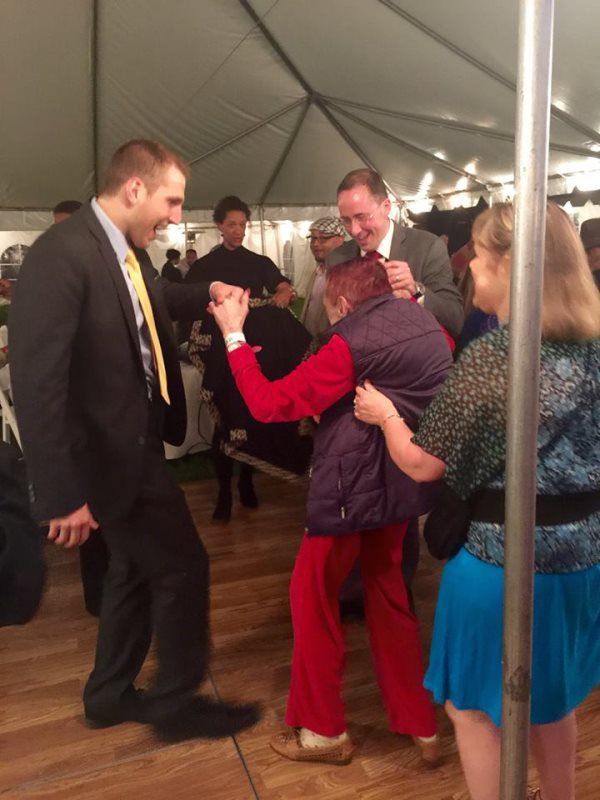 Residents and staff dancing at a celebration event