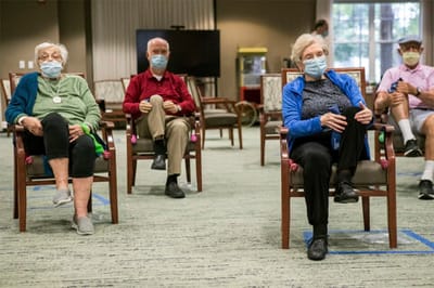 Residents participating in a seated activity in the common area