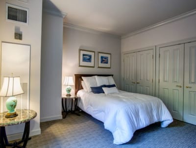A well-furnished private resident room with a bed and decor