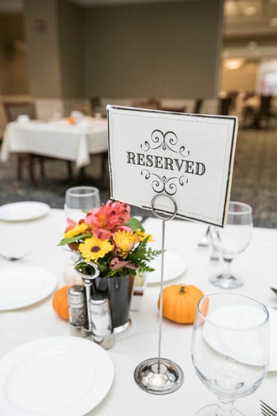 Reserved dining table with flowers and decor