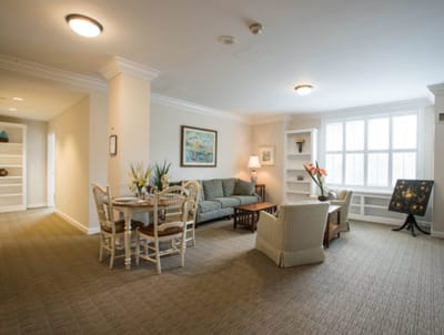 Bright common area with seating and dining space