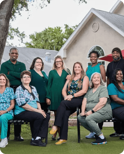 Staff members posing together in a garden area