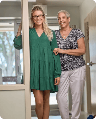 Two women smiling in a bright indoor setting