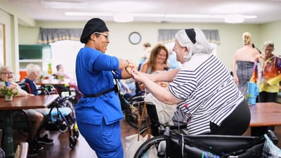 Residents and staff enjoying a lively activity in a communal space
