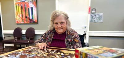 Resident working on a puzzle in a common area