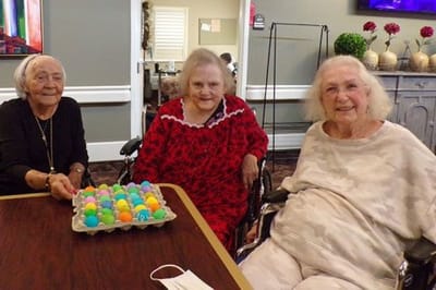 Residents enjoying an activity with colorful eggs