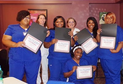 Staff members celebrating training achievements