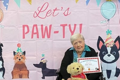 Resident celebrating with a pet adoption certificate