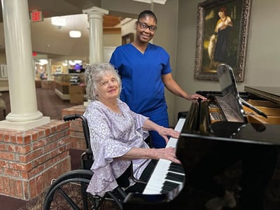 Landmark Nursing & Rehabilitation Ctr of West Mon, Nursing Home in West Monroe, LA — Woman in wheelchair playing piano with caregiver assistance