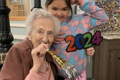 Landmark Nursing & Rehabilitation Ctr of West Mon, Nursing Home in West Monroe, LA — Celebration with an elderly woman and young girl holding signs