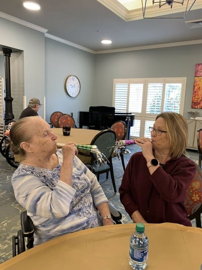 Landmark Nursing & Rehabilitation Ctr of West Mon, Nursing Home in West Monroe, LA — Two women celebrating with party blowers in common area