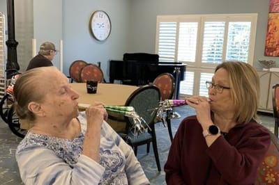 Landmark Nursing & Rehabilitation Ctr of West Mon, Nursing Home in West Monroe, LA — Two women celebrating with party blowers in a common area