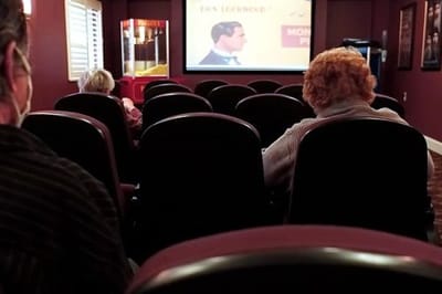 Residents watching a movie in a small theater
