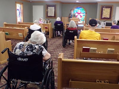Residents attending a service in a cozy chapel