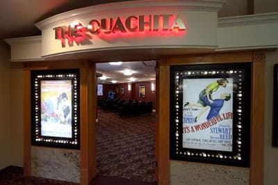 Entrance to a film screening room with movie posters