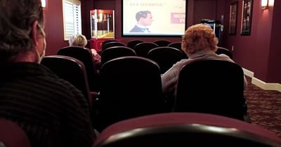 Residents watching a movie in the facility's theater