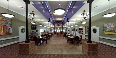 Interior view of a spacious common area with dining tables