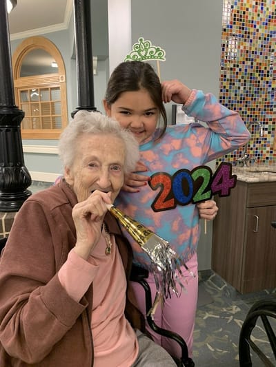 Landmark Nursing & Rehabilitation Ctr of West Mon, Nursing Home in West Monroe, LA — Elderly woman celebrating New Year's with young girl