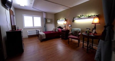 A cozy resident room with a bed and furniture