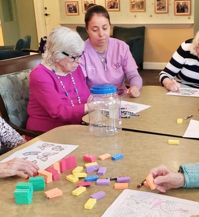 Residents participating in a coloring activity at a table