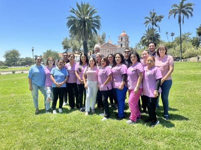 Staff posing together in an outdoor space