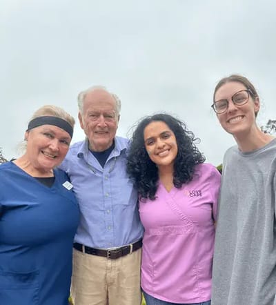 Staff and resident posing outdoors