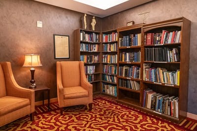 Cozy library area with bookshelves and armchairs