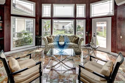 Bright common area with seating and large windows