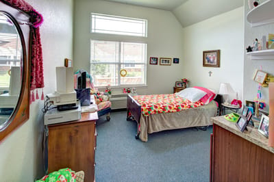 Bright private resident room with floral bedding
