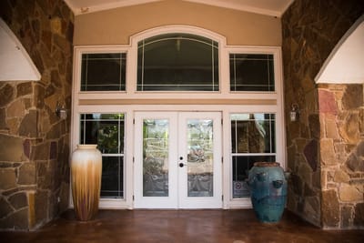Exterior entrance of the facility with decorative vases