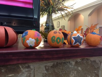 Residents' decorated pumpkins on a table