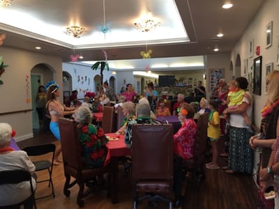 Residents and staff celebrating in a vibrant common area