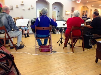 Residents enjoying a music activity in a common area