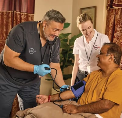 Healthcare staff assisting a resident
