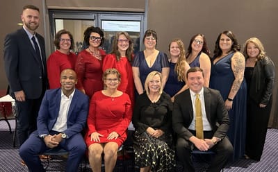 Staff and residents celebrating at a formal event