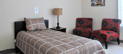 Cozy resident room with bed and seating area