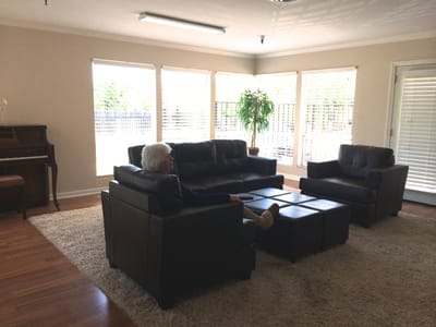 Resident relaxing in a common area with natural light