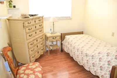 Cozy resident room with floral bedding and furniture