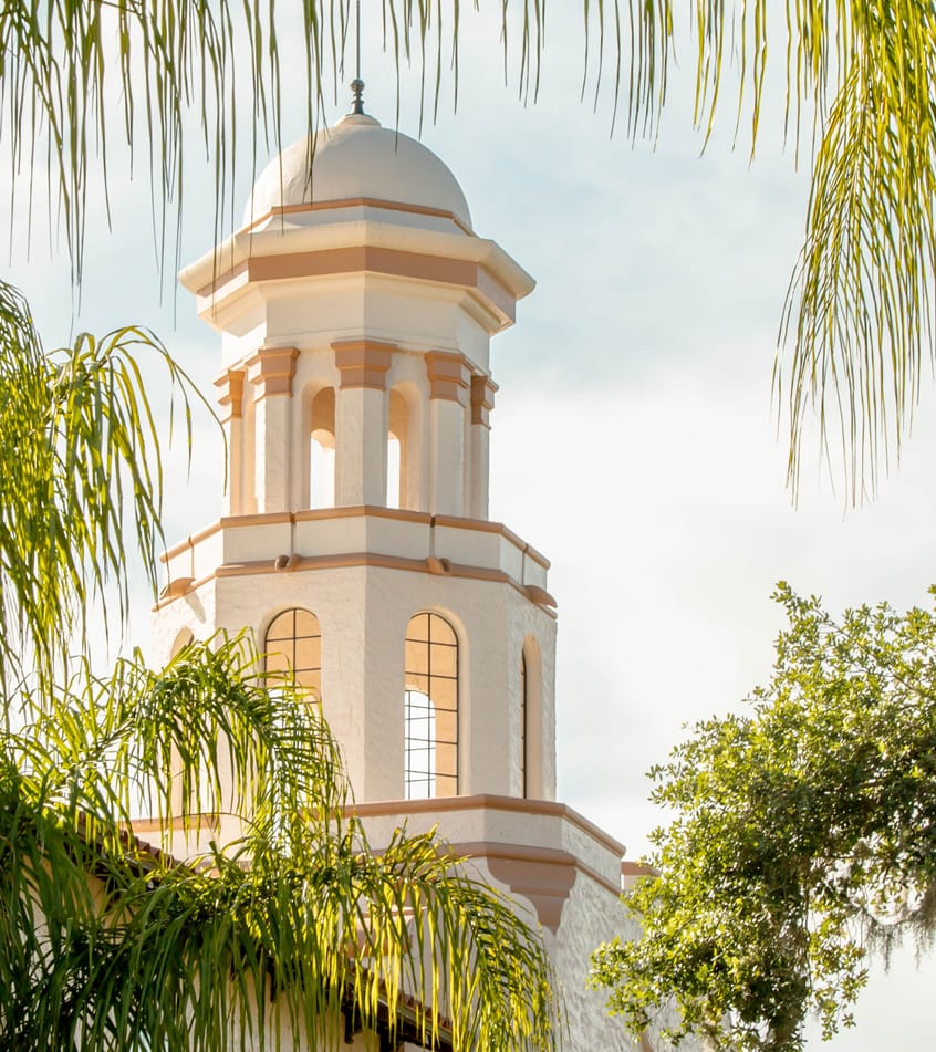 Exterior view of a facility tower surrounded by greenery