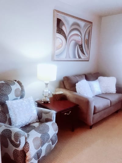 Cozy seating area in a resident room with decorative art