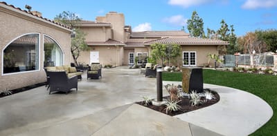 Outdoor patio area with seating and landscaping