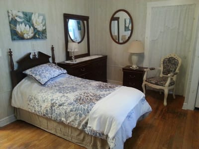 Cozy private room with floral decor and a wooden dresser